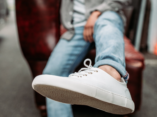 the low cut classic in white on white pictured with a man wearing jeans